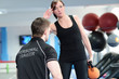 Young woman exercising with fitness instructor