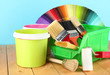 Paint pots, paintbrushes and coloured swatches