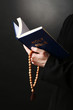 Priest reading from the holy bible, close up