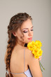 Young woman with beautiful hairstyle and flowers,