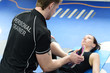 Personal trainer with girl stretching