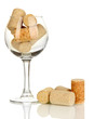 Wineglass and corks isolated on white