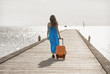 Young woman walking on wooden pier