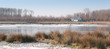 Country house on the edge of a lake with a thin layer of ice