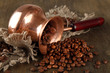 Coffee pot with coffee beans on wooden background
