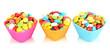 Colorful candies in cupcake cases isolated on white