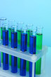 Identical test tubes on blue background