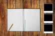 Photo: Notebook on wooden floor with photo frames Notebook on wooden floor with photo frames