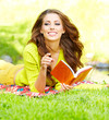 beautiful girl with book in  park
