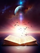 ancient open book with magic light and flying birds
