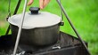 Fish soup in cast-iron cauldron on fire