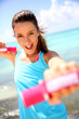 Photo: Cheerful girl lifting weights Cheerful girl lifting weights