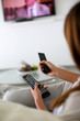 Closeup on remote control held by woman