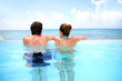 Couple looking at the sea from swimming-pool