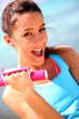 Photo: Cheerful girl lifting weights Cheerful girl lifting weights