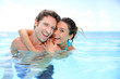 Photo: Couple having fun in swimming-pool Couple having fun in swimming-pool