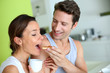 Cheerful couple enjoying breakfast time