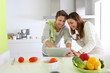 Couple in home kitchen looking for lunch recipe