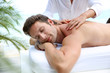 Handsome man laying on a massage bed