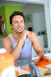 Man using smartphone while having breakfast