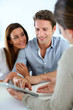 Photo: Young couple meeting financial adviser Young couple meeting financial adviser