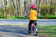 Photo: Little boy riding away from the viewer Little boy riding away from the viewer