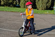 Happy confident little boy on his bike
