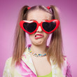 Close-up portrait of young woman in funny glasses with annoyed g