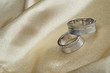 Wedding rings on a beige satin