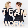Two business women presenting teamwork