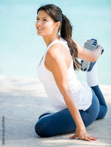 Photo: Woman stretching outdoors Woman stretching outdoors