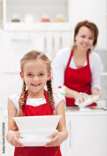 Photo: Little girtl helping mother to do the dishes Little girtl helping mother to do the dishes