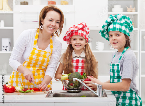 Photo: Kids helping mother in the kitchen Kids helping mother in the kitchen