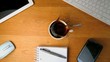 Spoon falling into  coffee and splashing a desk with tablet pc