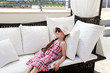 Photo: Tired little girl relaxing on terrace divan Tired little girl relaxing on terrace divan