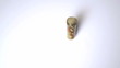 Jar of pills falling on white surface