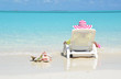 Girl in a striped hat on the beach of Exuma, Bahamas