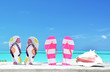 Photo: Two pairs of flip-flops and a shell Two pairs of flip-flops and a shell