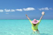 Girl with a seashell in the turqouise water. Exuma, Bahamas