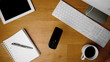 Mobile phone falling onto office desk