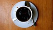 Sugar lump falling in coffee cup