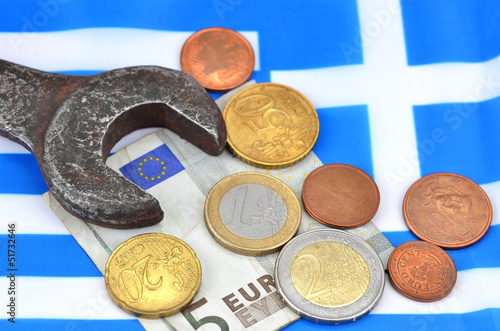 Photo: Earning in Greece concept with Euro money, flag and wrench Earning in Greece concept with Euro money, flag and wrench