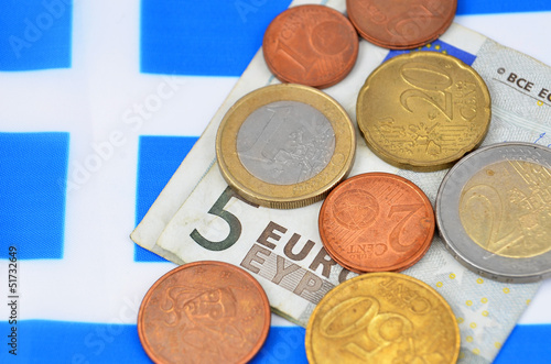 Photo: Earning in Greece concept with Euro money and flag Earning in Greece concept with Euro money and flag