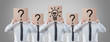 businessmen holding a card on head