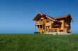 Modern wooden cottage on the green lawn