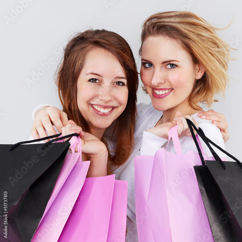 Photo: Two pretty girls with shopping bags are so happy Two pretty girls with shopping bags are so happy
