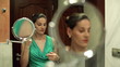 Video: Woman doing makeup in front of mirror and talking on cellphone Woman doing makeup in front of mirror and talking on cellphone