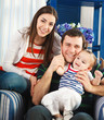 Happy smiling family with one year old baby