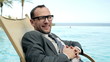 Portrait of businessman in tourist resort smiling to the camera,