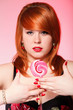 happy redhair woman with lollipop candy